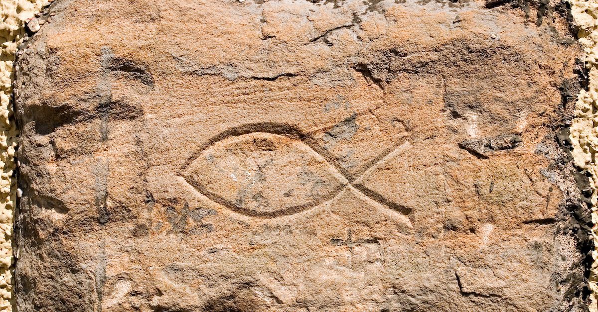 christian fish symbol in sand