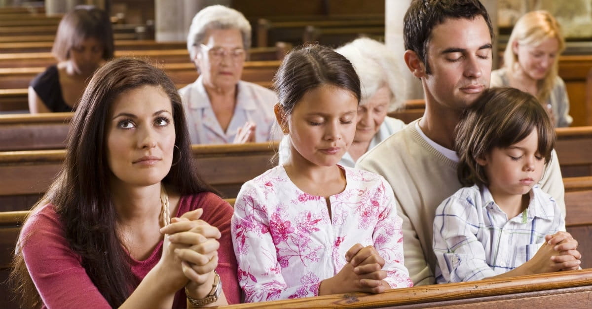 family praying in church