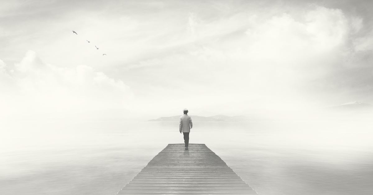 man walking on gray bridge with gray background, depression