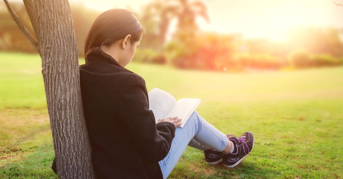 young girl reading outside by tree, quotes for teens