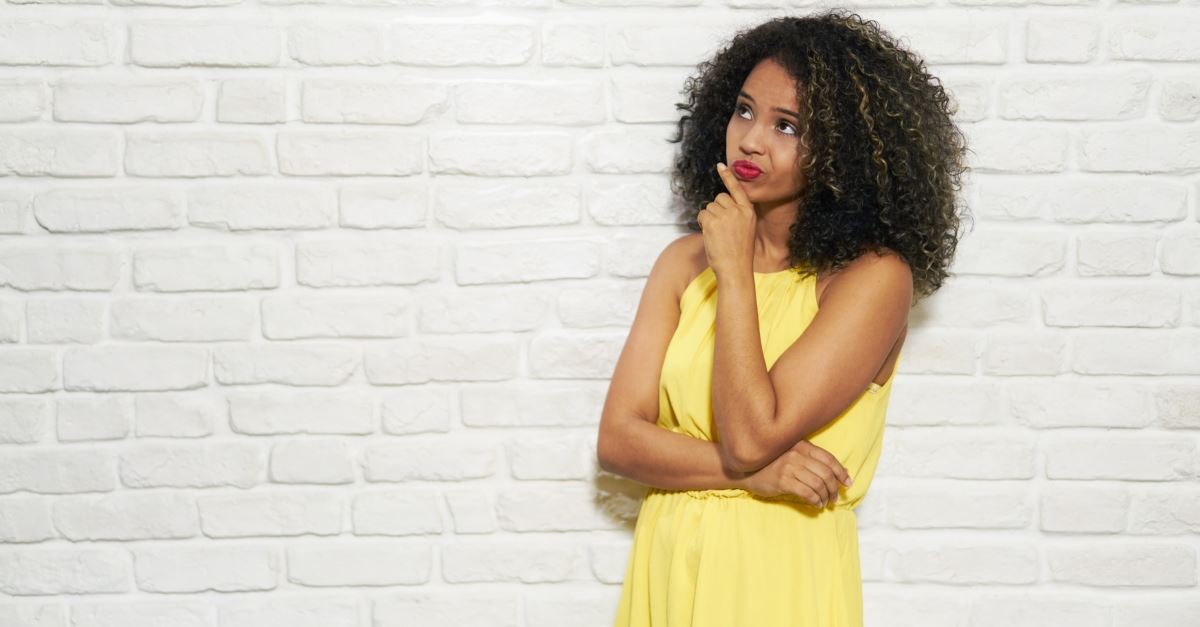 woman in front of a white brick wall thinking, popular statement that are theologically unsound