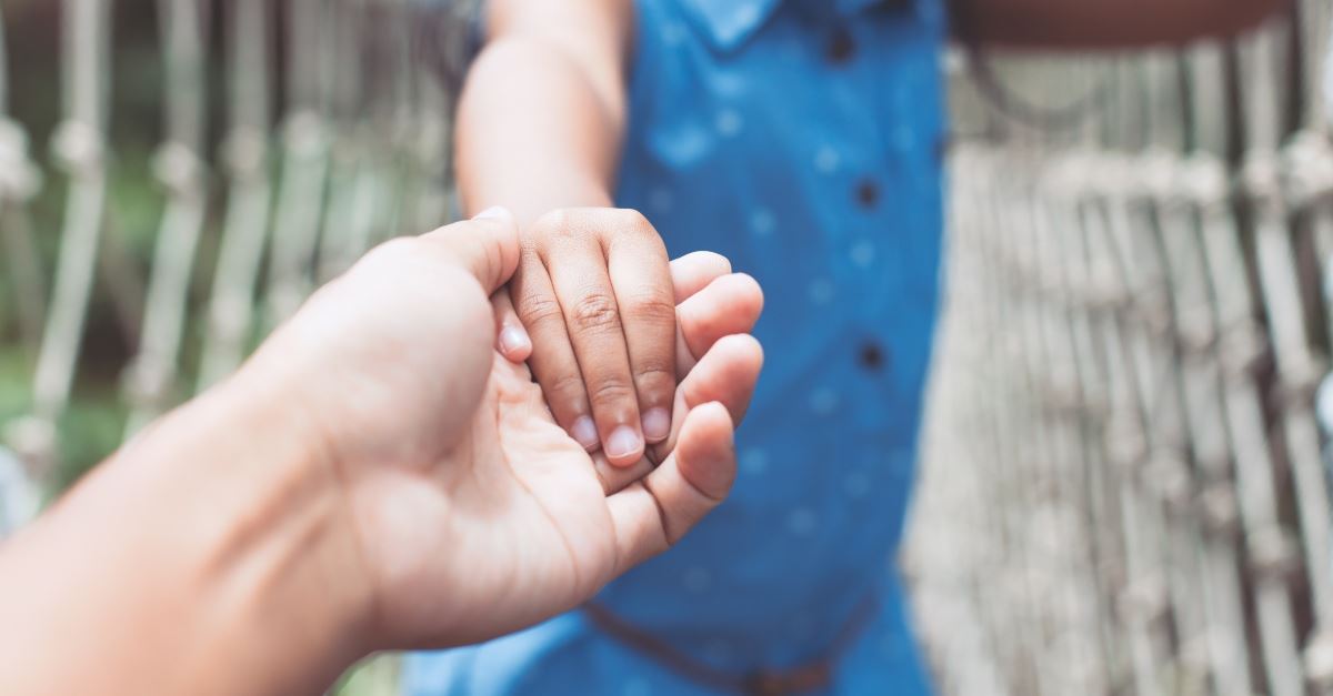 parent holding hand of child outstretched, discipling children can change generation