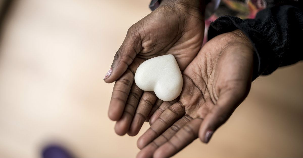 hand holding a stone in the shape of a heart, pictures of revelation