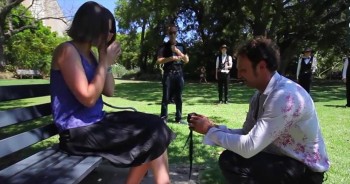 Jason pulled out all the stops to propose to the woman of his dreams.  The perfect setting, marching bands, and another surprise performance after he popped the question.  This is beautiful!