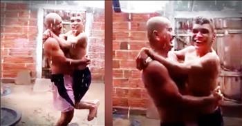 Dad Carries Son To Feel The Rain For The First Time