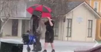 In a hailstorm, a teen makes his way to the sidewalk to provide umbrella shelter for a disabled person who must use a walker.  We are reminded that there are still many young who are being taught the way of the Lord...to be kind and loving. God Bless this boy and his family for teaching him the Golden Rule. <3