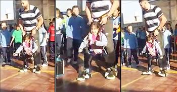 This physical education teacher wanted to make sure that all of his students were involved in a recent dance. One of his students has a disability that prevents her from walking, so this amazing teacher did the incredible. 

He used a device that allowed the girl to be strapped to him and he could control her movement. The teacher was able to take the young girl onto the dance floor and let her enjoy the time of her life. 

This precious moment was captured on camera and it will truly make your heart soar. I wish we had more people in the world like this guy!