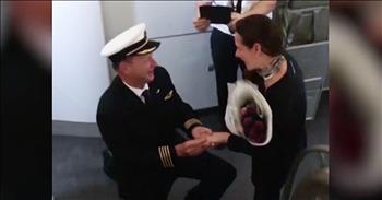 Qantas pilot, Captain Dooley Ellis was all set for take off when he decided to make a very special announcement over the intercom. Ellis' girlfriend, Anna, was traveling on the flight to South America to visit her family, but this captain wanted to "make sure she comes back to me in Australia." 

That's when he pulled out all the stops and asked for her hand in marriage. You can see the shocked look on her face and it's absolutely priceless. 

And when she finally said 'yes' I was jumping up and down from excitement. What a precious surprise proposal. Who else wishes they could see something like this in person?