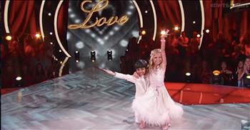 We are completely L-O-V-E over this adorable duo’s recent fox trot performance on Dancing With The Stars: Juniors! Akash & Kamri obviously worked hard on this routine and their choice in song was spot on. There is something truly moving about Nat King Cole’s “L-O-V-E” that makes us want to get up and dance as well! 

From the first camera angle on adorable Kamri Peterson, we were hooked! This 10-year-old from Utah has been studying dance since she was able to walk. Her biography on the show’s website shares that she really loves Ballroom and has won many titles in the dance world. Paired with Spelling Bee star, Akash Vukoti these kids have amazing charisma! He may be small but he truly packs a lot of personality into every step! Who would have thought that Akash could move so effortlessly for someone so young and with very little training. 

The fox trot is one of our favorite dances and that might be partially because of the beautiful dresses that the women wear! Kamri was dressed in a gorgeous flowing gown that bellowed out into a stunning wave of feathers! With every step her dress was accentuating the lines of the dance – including the amazing aerial jump in the middle of the dance!

It’s clear that these two truly L-O-V-E dancing together and are really getting into the joy of dancing. Their smiles during the song were absolutely radiant. We loved Akash and Kamri’s sweet hug at the end of their dance. They showed such joy and overwhelming excitement as they prepared to meet the judges. There’s no question that they were pleased with their hard-earned performance and had a lot of fun in the moment!