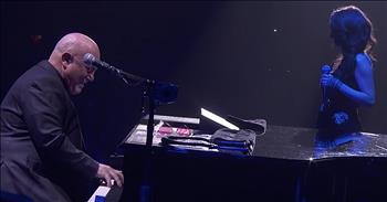 Award-winning singer-songwriter Billy Joel and daughter, Alexa Ray Joel, sing a beautiful duet of ‘New York State Of Mind.’ 

This iconic song was originally written by Billy Joel in 1976 and featured on his ‘Turnstiles’ album. Even though the tune wasn’t an instant hit, it later became a cultural phenomenon covered by countless artists. This is also a popular song for Billy to perform at his concerts. 

Today, he is joined by a very special guest for an amazing duet of this classic. 33-year-old Alexa Ray Joel is also a singer and songwriter, just like her father. 

During Billy’s Madison Square Garden Valentine’s Day concert, he brought Alexa on stage and they belted out the lyrics to ‘New York State Of Mind.’

“Some folks like to get away, 
Take a holiday from the neighborhood
Hop a flight to Miami Beach or to Hollywood
But I'm takin' a Greyhound on the Hudson River line
I'm in a New York state of mind”

Billy plays the piano while Alexa’s distinctive voice sings the famous lyrics. 

This father-daughter duo obviously have a lot in common and it’s so amazing that their talents overlap. It is always so sweet to see the relationship between parents and their children but this one is extra special. 

Alexa is performing this song for a whole new audience so that her father’s songs can truly touch the next generation. And the look of joy and pride in Billy Joel’s eyes is the topping on this incredible performance. Simply tremendous!