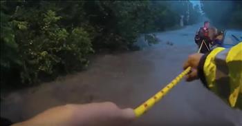 It was a nerve-wrecking moment captured on camera when officers rescue 3 women and a dog trapped in flood waters. 

After a sudden flash flood, the car these women were in became stuck on a bridge. As the water rushed past, there was no way to get out of the vehicle. 

It soon became apparent that the strong flow of water was going to push the car into the lake. That’s when the women dialed 911 to receive help. “We’re about to get pushed into a lake. We need to get out ASAP.” 

Texas police officers showed up on scene and quickly worked to rescue the women. They threw out a line of rope to help guide the women to safety. One by one, officers guided the women towards protection. 

But when the last women stepped out of the car, she was clinging to her dog. She refused to let go of her beloved canine for fear that he would be swept away. But as the car became unsteady, the officer knew that they needed to move quickly. 

He guided the women to safety but the dog broke free of the grasp and tried to run away. Thankfully, the cops were able to beckon him back to higher ground. Just seconds after everyone was removed from the vehicle, the raging waters carried the car over the bridge. 

The police officers arrived just in the nick of time to save these three women. God definitely placed these cops in the right place at the right time. Prayers for everyone involved. 