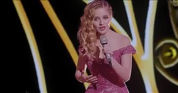 Powerhouse voice Jackie Evancho competes in the world championships with a beautiful combination of ‘O Mio Babbino Caro’ and ‘Nessun Dorma.’

Jackie Evancho became a worldwide sensation after being crowned runner-up on the fifth season of America’s Got Talent. She was just ten years old when she made her appearance on the popular talent competition. Her classical vocals combined with high range made Jackie a standout during the series. Now, at the age of eighteen, she is back on the stage competing on World’s Got Talent. Before her performance, Jackie addressed the judges. 

David Foster vividly remembered this child star and raved about her to the panel. “I followed her career on America’s Got Talent where she was the runner-up and she should have been the winner. But she’s had an amazing career around the world. Just wait until you hear her sing. You’re not gonna believe it.” As her dad waited in the wings, Jackie belted out the iconic lyrics to the song ‘O Mio Babbino Caro.’ 

Then, she combines this classic song with ‘Nessun Dorma.’ Her powerful opera vocals left the judges in awe. And when she hit that high note at the end, everyone was cheering. David Foster again sang her praises. “Jackie never ever ever disappoints.” 

For such a young women, Jackie definitely has a lot of talent. Over the years, she’s only gotten better and better. Jackie Evancho is certainly going to be a voice that we hear for many years to come. Don’t you agree?