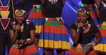 The Ndlovu Youth Choir bring their unique sound to the America’s Got Talent stage with an emotional audition.

Started in 2009, the choir is a creative outlet for kids in South Africa. Led by artistic director Ralf Schmitt, this talented group has gained a following all over the world. 

On their Facebook, it states that “the choir seeks to deliver an experience of infectious joy, a toe-tapping and energetic South African music ranging from Afro-Pop classics to traditional South African music and original compositions irresistibly combined with mesmerizing choreography.” 

With their special style of sound, this choir is providing hope to it’s member. Director Ralf said, “When they join us, many of our kids have the weight of the world on their shoulders and, to them, their problems feel insurmountable.”

Now, the group has traveled all the way to the United States for their chance at stardom. “For us, it’s not easy to dream, so I didn’t like to smile. But after joining the choir, I found my voice and it brought back the smile on my face.” 

The choir easily impressed the judges with their energetic performance of an original song, ‘My African Dream.’ The blend of vocal talent with dance truly makes this an audition to remember. But it was the symbolism of the moment that brought Ralf to tears. 

“They come from one of the poorest communities in the world, yet these kids managed to lift themselves up. To see them standing on the stage of America’s Got Talent tonight, you can’t help but just burst with pride.” The Ndlovu Youth Choir is definitely an act to keep your eye on. 
