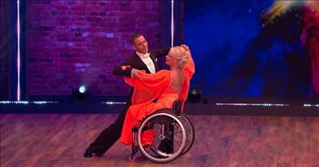 In this stunning ballroom dance audition, a woman in a wheelchair defies the odds with her incredible performance.
 
Alex and Jacqueline are a married ballroom couple who refuse to let a disability get in the way of their dreams. They performed an amazing dance routine together on a show called The Greatest Dancer. On the show Cheryl, Matthew Morrison, Oti Mabuse, and Todrick Hall are the judges, also known as Dance Captains, who are searching for the greatest dancer in the UK.
 
When the dance starts, Alex and Jacqueline can be seen dancing around in a video on a large screen on stage. Alex is in a dapper looking tuxedo, and Jacqueline is in her wheelchair in a beautiful orange dress. The sleeves of the dress are long and flowy, and they add a soft and dramatic effect whenever Alex turns her around.
 
Soon, the large screen on stage parts down the middle and Alex and Jacqueline can be seen dancing their hearts out on stage in front of the judges. They dance so beautifully together. At one point, Alex even lifts Jacqueline high above his head in a stunning and impressive move. All of the judges’ jaws drop at this sight and the audience erupts into loud cheers.
 
The way these two lovebirds move and dance across the stage together is pure artistry and beauty. And it is so inspiring to see them moving beyond the limits that society might think that people in wheelchairs have.
 
At the end of the dance, Alex and Jacqueline share a romantic kiss as Alex softly dips her. The judges and audience give them a big round of applause for their incredible performance! What an amazing dance and couple. Their efforts prove that anyone can do anything if they put their heart into it!
