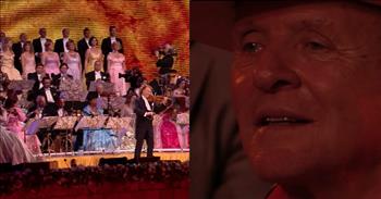 In this moving video, an orchestra teams up with Anthony Hopkins and performs an original composition of his decades later.
 
Not only is Sir Anthony Hopkins an incredible actor, but he is a talented composer as well! Titled “And The Waltz Goes On,” this piece by Hopkins was performed by André Rieu & His Johann Strauss Orchestra. At the beginning of this video, you can see the look of excitement on Anthony Hopkins’s face as the orchestra is about to start playing his piece.
 
The music starts off with light string plucking. Then a clarinet plays a few low notes, followed by a saxophone. The string section comes in next, adding a fullness to the music. Later, the conductor even grabs a violin and joins the orchestra in playing the beautiful melody.
 
As the music swells and a choir onstage joins in with the musicians, you can feel the magic and energy that is captivating everyone there. Some audience members can be seen swaying as they feel the movement of the music, others are so drawn to the music that they can’t look away from the stage.
 
Anthony Hopkins is seen smiling ear to ear and looking around to see if others are enjoying the piece that he composed. He can even be seen humming parts of the melody in certain parts. As he is taking in the sight, he tears up realizing how this wonderful orchestra is performing his original composition decades after he wrote it down.
 
While the song has a more mysterious feel at the beginning, halfway through the melody becomes a bit more playful and fun. People in the audience start dancing in their seats and can’t help but smile at one another. Even the musicians on stage look like they are having a grand time!
 
One person on YouTube comments about the music and says, “It's beautiful... there is love, happiness, playfulness, and a shy reserved nature about it. I suspect much like the man who wrote it.”
 
Anthony Hopkins did an outstanding job creating this dramatic piece of music, and the talented musicians did a wonderful job bringing it to life as well. This magnificent piece is hauntingly enchanting with a melody that you will be humming along to long after you hear it.
