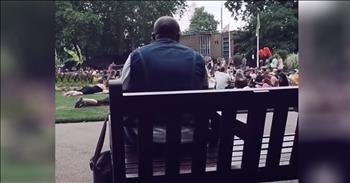 It was an incredible moment captured on camera with this man on a park bench started an impromptu concert of ‘Livin’ On A Prayer.’ 

This iconic rock song was originally recorded by the band, Bon Jovi. It was an instant hit for the group and continues to stand the test of time as one of the greatest songs ever. 

So, it’s no surprise that someone would choose this tune to belt out in front of a large crowd. And that’s exactly what happened when this man on a park bench started to sing the beloved lyrics.

“We've got to hold on to what we've got
It doesn't make a difference if we make it or not
We've got each other and that's a lot for love
We'll give it a shot”

As the man starts to sing, you can see people all over the park turn to see where the music is coming from. There are smiles, nods and even some quizzical looks. But then, the most amazing thing starts to happen. 

Voices from all over the area start to join in for this impromptu rendition of ‘Livin’ On A Prayer.’ And when they hit the chorus, everyone was singing their heart out.

“Woah, we're half way there
Woah, livin' on a prayer
Take my hand, we'll make it I swear
Woah, livin' on a prayer”

This incredible moment just proves that it only takes one person to create a movement. This simple act set off a wave of joy that radiated through the entire park. And now, the Internet is able to join on the happiness too. 

Who else is singing along to this rock hit?
