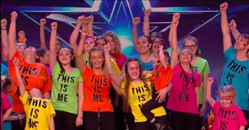 An inspirational choir’s moving performance on Britain’s Got Talent earned them the golden buzzer with their ASL rendition of ‘This Is Me.’
 
Jade and her 4-year-old brother, Christian, are the founders of the Sing Along With Us choir. It all started when Jade found out that her younger brother may never be able to talk.
 
“We were told that Christian would never be able to communicate. I taught him sign language so then he could talk. And he’s here, a little miracle, proving everybody wrong,” shares Jade.
 
“I didn’t want to accept that Christian would never be able to communicate. I just knew that there was a voice in there that needed to come out,” Jade says. “We decided that we wanted to teach other people this, so we started a class. We’re just amazed at how many people wanted to get involved.”
 
That small group of people wanting to learn ASL grew into a huge choir, and they are using what Jade has taught them to show the audience what it truly means to be themselves.
 
“We would never normally get an opportunity to do something like this. It’s unbelievable. We’re just so excited,” says Jade.
 
At the start of their audition, the choir starts singing ‘This Is Me’ while Jade uses ASL from the front of the stage to sign the lyrics. Then the whole group joins Jade with ASL and starts signing the song.
 
“When the sharpest words wanna cut me down
I'm gonna send a flood, gonna drown them out
I am brave, I am bruised
I am who I'm meant to be, this is me
Look out 'cause here I come
And I'm marching on to the beat I drum
I'm not scared to be seen
I make no apologies, this is me”
 
While they are performing, the audience members can’t stop smiling and cheering and many of the judges have tears in their eyes. After their moving performance, the judges have nothing but praise for the choir.
 
“You sang ‘This Is Me’ and I’m thinking, ‘You Are Us,’ because you define what this show should be all about,” Simon Cowell shares. “This is an audition that I will never, ever forget.”
 
It was so wonderful to see this inspirational group get a golden buzzer after they gave everything they had to this performance and shared such a positive message through their audition.
