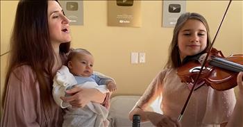 Enjoy this beautiful mother-daughter duet to ‘Hallelujah’ for the brand new baby in the family. 

The powerful song was originally released in 1984, but it wasn’t until Jeff Buckley released the song on his 1994 album, ‘Grace’ that the song really started to gain momentum. 

Since that time, ‘Hallelujah’ become a worldwide phenomenon and truly cemented itself in music history. Over the years, many artists have covered the tune and it’s a popular song selection for auditions and showcases. The unique tune sounds like a perfect blend of a rock ballad and a gospel song. 

“Well it goes like this 
The fourth, the fifth, the minor fall and the major lift 
The baffled king composing Hallelujah 
Hallelujah, Hallelujah 
Hallelujah, Hallelujah” 

Today, Karolina Protsenko and her mother are performing their own rendition of this classic song. You may recognize Karolina from one of her many viral violin performances, including songs such as ‘Can’t Help Falling In Love’ and ‘The Prayer.’ 

For years, she has shared her musical talents with the world. Karolina is truly a talented teen and the Internet seems to agree. With over 10 million views across social media, Karolina is making a name for herself as an artist on the move. 

Now, Karolina is also taking on another important role, big sister. Karolina’s mother recently welcomed a new baby boy and they’re already introducing the newborn to some beautiful tunes. Just listen as they play the iconic melody of ‘Hallelujah’ while the baby stays wide-eyed the entire time. What a sweet way to induct him into the musical family. 
