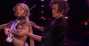 It never gets old watching the incredible talent of individuals. In this video, popular beloved violinist Lindsey Stirling teams up with an AGT magician for an unforgettable performance.

Champion Shin Lim performs another amazing act for AGT. He has the judge Heidi draw on a card what she feels brings people together. She draws a heart on the queen of hearts. He then has Heidi sit down and introduces violinist Lindsey Stirling. While she dances and plays. Shin moves cards. To reveal the heart has now been placed on every single card. He then incredibly fans out the cards and slides one card, queen of hearts, onto the back of the violin as Lindsey plays. Then suddenly as she dances around and the card appears on the bow which Shin is holding.

Shin uses the bow and creates a fiery hole in the shape of a heart in the card. However, he turns the card to reveal it untainted. Next, Shin places the heart card on the piano stand and pushes the bow through the heart and stand. The audience cheers. The two end their performance and the crowd gives a standing ovation.

I find it interesting that in the video Heidi put a heart as what brings people together. Love does unify, however, we know that God is Love. He is the one who brings true unity. We are one because of Jesus.  He shares that we are one in Christ Jesus.

“For as many of you as were baptized into Christ have put on Christ. There is neither Jew nor Greek, there is neither slave nor free, there is no male and female, for you are all one in Christ Jesus.” <a href="https://www.godtube.com/bible/galatians/3-27">Galatians 3:27-28</a>
