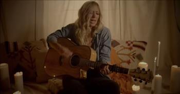 Check out this beautiful song called ‘Gold’ by Ellie Holcomb and featuring Carly Bannister.
 
“You were a quiet boy growing up in the heart of Texas, you had a quiet father too
He built the car you drove, it was a '69 and '70 Mustang, he took two halves of broken cars
And made 'em new, you sat there in the garage, there was oil on his hands
He didn't tell you much, so I hope you understand, that you are wonderful, you are kind
You are patient, you are humble, and you are wise, you don't see it with your own eyes
But you are gold to me and I love the way you shinе”
 
In the music video, Ellie is singing on the floor and playing her guitar with pillows and candles around her. The heartwarming song is moving and the lyrics are so beautiful.
 
The song ‘Gold’ is actually a tender tribute to Ellie’s father’s story, and it features harmonies from her four siblings.
 
“The journey that the lyrics of this song take you on is...I don't know what to say...it's so amazing!” <a href="https://www.youtube.com/watch?v=_TUxkgbY6xk">comments</a> one person online after watching the music video.
 
“That was precious. I've not heard many songs that uplift a son, so this is really nice. They are so tender,” <a href="https://www.youtube.com/watch?v=_TUxkgbY6xk">writes</a> another person on YouTube.
 
The song ‘Gold’ is part of Ellie’s new <a href="https://www.ellieholcomb.com/news/2016/11/8/about-ellie">album</a> titled Canyon. And although many songs on Canyon “explore the presence of God in the valley, there are also songs that boast of the redemption found on the mountaintop.”
 
“In some ways, the deeper the pain, the more powerful the healing,” <a href="https://www.ellieholcomb.com/news/2016/11/8/about-ellie">shares</a> Ellie. “The darker the night, the brighter the light shines. The wider the canyon of ache that splits our hearts in two, the more space for love to move in and fill up what’s been emptied out, to bind up our broken hearts and remind us that suffering never gets the final word, even though it shapes us.”
 
We hope that you enjoyed listening to this beautiful song by Ellie Holcomb today!
