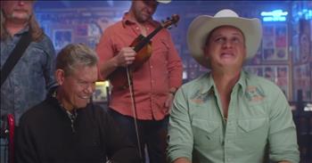 There is nothing like meeting your hero. In this video, a country artist is moved to tears after Randy Travis appears on stage with him.
 
Singer Jon Pardi got an unexpected surprise when he thought that he was honoring Randy Travis as the 2021 Artist of a Lifetime for CMT. 

Jon says that Randy influences him as an artist and he is one of his heroes. While Jon was celebrating Randy’s music, Randy shows up in the room. Jon says, “What?!” He smiles and Randy smiles back. Jon replies, “Well hey, Randy, this is a surprise.” 

Mary, Randy’s wife, expresses her gratitude to be at the Palace hearing Randy’s music. The restaurant where they are honoring him was where Randy worked as a cook and dishwasher, and they put him up on the stage. The rest is history. 

At the end of the song Jon sings next to Randy and his wife, he chokes back tears. Jon had what was probably one of the best days of his life.

Thinking about how Jon was so amazed and humbled to be in the presence of his hero, reminds us about how we are to be even more so with God. Jesus is our ultimate Hero who died on the cross for our sins and just as Randy came to Jon, Jesus came to us. 

In the midst of our sin, Christ died for us. He is with us always through the gift of the Holy Spirit and one day, we too will have tears of joy at the sight of the face of our great God.

“And I heard a loud voice from the throne saying: “Behold, the dwelling place of God is with man, and He will dwell with them. They will be His people, and God Himself will be with them as their God.‘He will wipe away every tear from their eyes,’ and there will be no more death or mourning or crying or pain, for the former things have passed away.’” <a href="https://www.godtube.com/bible/revelation/21-3">Revelation 21:3</a>
