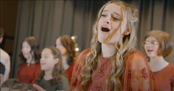 <p>For Christians, Christmastime is clearly about celebrating the birth of Jesus, but in this video featuring 16-year-old Reese Oliveira and a group of talented friends performing &ldquo;I Sing of Christmas&rdquo;&mdash;well, we are reminded of much more than just His birth!</p>

<p>As the video begins, a pair of young hands hang a crimson ornament on a Christmas tree festooned in gold, green, and red. The lead performer, Reese Oliveira, appears from behind a gold drape and begins singing. She finishes the first verse, the curtain opens, and we now see a manger scene with a duo of child actors and one cute, if a bit &ldquo;stiff,&rdquo; baby doll depicting the holy family.&nbsp;</p>

<p>Reese, in modern-day clothing, bends down to the manger and continues singing. With the beginning of verse two, several others join those already on stage. There is a twirling star, reminding us of the one the shepherds followed. However, the lyrics of the song Reese sings go a bit further. The words also remind us to be a light in a dark world when we are called to do so.&nbsp;</p>

<p>There is a triad of handsome wise men, and a shepherd who might just have his hands full with three of the cutest tutu-clad sheep in the valley! A choir of kids, who appear to be anywhere from 5 to 17, back up Reese on the song&rsquo;s bridge. Their beautiful, smiling faces reflect the joy that Christmas brings to the world!&nbsp;</p>

<p>The final vignette shows Reese presenting gifts to three cherubs in pajamas. One is the ornament we saw at the start&mdash;a cardinal. Reese sings of how the red ornaments hanging on our trees serve as expressions of how Jesus&rsquo;s blood was shed on the cross at the end of His earthly life. The entire cast and choir returns for the final chorus, which goes as follows:</p>

<p>I sing shepherds and wisemen, God&rsquo;s love divine<br />
Miracles, teachings, His gospel sublime<br />
I sing of Him&hellip;Beginning and End<br />
Oh I sing of Christmas, my King, my friend.</p>

<p>Reese is the eldest of five children in her Utah family, and she is an abundantly talented young lady. Reese has an impressive resume of vocal, dance, and musical theater accomplishments and experiences. Her acting and singing friends are delightful as well.</p>

<p>Suzanne Hodson is the writer of &ldquo;I Sing of Christmas,&rdquo; which may be new to you. It was written in 2020. Suzanne wrote on her <a href="https://m.facebook.com/story.php?story_fbid=735805397290484&amp;id=254089295462099&amp;m_entstream_source=timeline">Facebook post</a> that she wrote the song at a time that was especially challenging. Suzanne wanted to write a song of praise and joy for Jesus, because He is the one who brings light, love, and hope to the world. Amen, Sister!&nbsp;</p>

<p>&ldquo;I Sing of Christmas&rdquo; may one day be a classic Christmas song not only for its beautiful melody, but for its truest of words!</p>

<p><br />
Today in the town of David a Savior has been born to you; he is the Messiah, the Lord. <a href="https://www.godtube.com/bible/luke/2-11">Luke 2:11</a></p>
