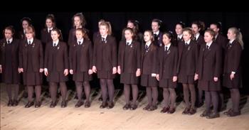 <p>This all-girls choir sings a unique rendition of Queen&rsquo;s &ldquo;Bohemian Rhapsody&rdquo; in this performance by the Frensham Madrigals.&nbsp;</p>

<p>Frensham is a girls&rsquo; boarding school and day school in Mittagong, Australia. And, the British band Queen is one of the most well-known rock groups of all time. Watch how these young ladies pay homage to Queen and their 1975 superhit!</p>

<p>Twenty high school girls are dressed in basic brown uniforms. They wear black ties and clunky brown shoes, and each has her hair fixed in a ponytail. The look is anything but rock and roll. Honestly, it&rsquo;s just not very flashy&mdash;and certainly not colorful. And that&rsquo;s totally fine.</p>

<p>Because, what the performance &lsquo;lacks&rsquo; in costumes and crazy make-up, it makes up for with lighting and choreography that are impeccably timed and executed, and voices that harmonize and hit the notes with perfection!&nbsp;&nbsp;&nbsp;</p>

<p>The performance opens with the girls looking down and the stage dimly lit. They sing the slow opening to the classic, but the lights come on just as they lift their faces to render the words &ldquo;open your eyes.&rdquo; And, heads are bowed once again when soloist Charlotte Nicholls moves forward to deliver the first verse. It&rsquo;s a weighty lyric for a proper young lady!</p>

<p>Charlotte is joined by Katie Lee, who finishes that verse. Then, the ensemble comes back together to cry out to &ldquo;Mama.&rdquo; The use of shadows and light is reminiscent of the video of <a href="https://www.youtube.com/watch?v=fJ9rUzIMcZQ">Queen&rsquo;s own performance</a>.&nbsp;&nbsp;&nbsp;</p>

<p>As verse two rounds out, you might notice that three of the students have purple trim on their jacket lapels. A <a href="https://www.frensham.nsw.edu.au/community/news-events/news/details/~board/news-page/post/purple-green-and-white">purple iris</a> is the emblem for Frensham, because it is believed to represent beauty, strength, and an ability to prosper in various conditions.&nbsp;</p>

<p>The piano bridge provides time for the singers to position themselves. Then, at the precise moment, they turn crisply toward the center to begin the operatic portion. A few more clever and music-complimenting moves bring us right to the big surprise. The crowd loves it when the madrigals take a few moments for headbanging and air guitar playing!</p>

<p>Just as the songstresses turned rowdy, they returned to formality for the final minute of the performance. They bring Mr. Mercury&rsquo;s song to a close with lights dimmed and heads bowed once again. Great job, Frensham friends, and thanks for the fun!</p>

<p><em>&ldquo;She is clothed with strength and dignity; she can laugh at the days to come.&rdquo; <a href="https://www.godtube.com/bible/proverbs/31-25">Proverbs 31:25</a></em></p>
