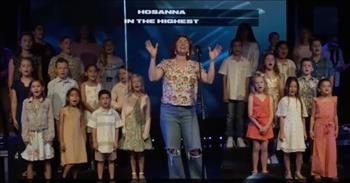 <p>Check out this video of Kim Walker-Smith and a children's choir singing 'Hosanna' from Hillsong United.</p>

<p>&ldquo;I see a generation rising up to take their place, with selfless faith, with selfless faith<br />
I see a near revival, stirring as we pray and seek, we're on our knees, we're on our knees<br />
Hosanna, Hosanna, Hosanna in the highest, Hosanna, Hosanna, Hosanna in the highest&rdquo;</p>

<p>What a powerful scene that will give you chills! It is just so heartwarming to see all of those children on stage worshiping their Heavenly Father!</p>

<p>Kim Walker-Smith and this children's choir were performing this version of &lsquo;Hosanna&rsquo; at Influence Church back in April 2022. And they all sound wonderful together!</p>

<p>&ldquo;Beautiful, so much feeling behind this worship,&rdquo; <a href="https://www.youtube.com/watch?v=h9dbK7btalI">comments</a> one person on YouTube after watching the video. &ldquo;How lovely to have the children sing Hosanna.&rdquo;</p>

<p>&ldquo;Yes Lord, raise up children who know you and worship you,&rdquo; <a href="https://www.youtube.com/watch?v=h9dbK7btalI">writes</a> another person online. &ldquo;Worship is healing to the soul of mankind.&rdquo;</p>

<p>The song &lsquo;Hosanna&rsquo; was written back in 2006 by Brooke Ligertwood, a New Zealand-born singer and songwriter whose popular stage name and maiden name is Brooke Fraser. In addition to songwriting and leading worship for Hillsong Church, Brooke is a successful solo pop artist who has released four albums since 2003.</p>

<p>Kim Walker-Smith, the woman singing in this video, is a singer, songwriter, worship leader, and recording artist. Her first solo album was released in February 2008 through the Jesus Culture record label. Kim is also a worship pastor for Bethel Church in Redding, CA.</p>

<p>We hope that you enjoyed this version by Kim Walker-Smith and the talented children&rsquo;s choir of 'Hosanna.' Let the music uplift your spirit today!</p>

<p><em><a href="https://www.godtube.com/bible/psalms/8-2">Psalm 8:2</a><br />
Through the praise of children and infants you have established a stronghold against your enemies, to silence the foe and the avenger.</em></p>
