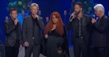 <p>Wynonna Judd, The Gaither Vocal Band and Larry Strickland perform a heartfelt rendition of &lsquo;How Great Thou Art.&rsquo;</p>

<p>This classic hymn was originally written in 1885 by Swedish evangelist, Rev. Carl Boberg. He is credited with setting the words to a Swedish folk melody.</p>

<p>The hymn then became translated to German, to Russian, and then into English by English missionary Stuart Hine. He was inspired while working in Ukraine and hearing a congregation sing the song in Russian.</p>

<p>However, &lsquo;How Great Thou Art' did not gain worldwide popularity until George Beverly Shea performed it on a Billy Graham crusade in 1957.</p>

<p>Now the iconic words are performed in churches all across the globe.</p>

<p>"O Lord, my God, when I in awesome wonder<br />
Consider all the worlds Thy Hands have made<br />
I see the stars, I hear the rolling thunder<br />
Thy power throughout the universe displayed&rdquo;</p>

<p>Today, musical legends Wynonna Judd, The Gaither Vocal Band and Larry Strickland come together for a stunning performance of &lsquo;How Great Thou Art.&rsquo;&nbsp;</p>

<p>This song was performed at the emotional tribute for the late Loretta Lynn titled, &lsquo;Coal Miner's Daughter: A Celebration of the Life and Music of Loretta Lynn.&rsquo;</p>

<p>Just listen as they belt out these beautiful words of worship.</p>

<p>&ldquo;Then sings my soul, my Saviour God, to Thee<br />
How great Thou art, how great Thou art<br />
Then sings my soul, my Saviour God, to Thee<br />
How great Thou art, how great Thou art"</p>

<p><em><a href="https://www.godtube.com/bible/isaiah/40-29">Isaiah 40:29 </a>&ldquo;He gives power to the faint; and to them that have no might he increases strength.&rdquo;</em></p>
