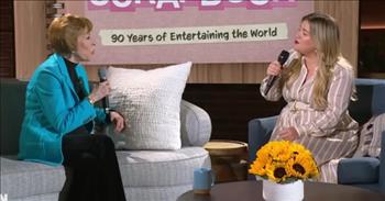 <p>One of the biggest names in music was joined by a comedy legend to sing an iconic and beloved song.</p>

<p>Carol Burnett has kept people laughing for decades. Due to her abundant comedic talent and lightning-fast wit, Carol always brought tons of fun and laughter to her television program, <em>The Carol Burnett Show</em>. Even decades later, <em>The Carol Burnett Show</em> remains a beloved program that still makes audiences laugh with its talented cast and off-the-wall sketches.&nbsp;</p>

<p>Carol repeatedly displayed her ability to send audiences and even her castmates into uncontrollable laughter. In addition to comedy, Carol showed she could sing, ending every episode by singing &ldquo;So Long.&rdquo;</p>

<p>During an appearance on <em>The Kelly Clarkson Show</em>, Carol didn&rsquo;t have to perform &ldquo;So Long&rdquo; solo. Instead, Kelly joined Carol and the two made it a beautiful duet.&nbsp;</p>

<p>While sitting down, Carol and Kelly belt out the lyrics that most people likely know by heart. About 30 seconds into the clip, Carol even does her signature move, which she did during every performance of &ldquo;So Long.&rdquo; She tugged on her left ear.</p>

<p>The two women sound terrific together! Despite her advanced age, Carol&rsquo;s voice still sounds great.&nbsp;</p>

<p>At the end of their song, Kelly throws herself back in her chair and is all smiles. It&rsquo;s obvious she cannot believe what she was privileged enough to do. Kelly then pops up out of her seat and gives Carol a warm and loving embrace.</p>

<p>Kelly obviously has a ton of respect for the talented and lovely Carol Burnett, who just turned 90 years old.&nbsp;</p>

<p>Right before the clip ends, Carol can be heard telling Kelly, &ldquo;You&rsquo;re a doll.&rdquo;</p>

<p>The audience also appreciates the television history that was made right before them. They erupt in a round of thunderous applause.&nbsp;</p>

<p>What an awesome, moving and touching moment between two very talented women.&nbsp;</p>

<p><em><a href="https://www.godtube.com/bible/psalms/105-2">Psalm 105:2</a> &ldquo;Sing to him, sing psalms to him: talk you all of his wondrous works.&rdquo;</em></p>
