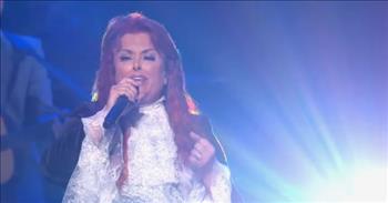 <p>Listen to this stunning performance by Wynonna Judd and other country artists of the song &lsquo;Love Can Build A Bridge.&rsquo;</p>

<p>&ldquo;I'd gladly walk across the desert with no shoes upon my feet, to share with you the last bite<br />
Of bread I had to eat, I would swim out to save you in your sea of broken dreams<br />
When all your hopes are sinkin' let me show you what love means<br />
Love can build a bridge between your heart and mine, love can build a bridge&rdquo;</p>

<p>This beautiful song was released in 1990, and it was written by Naomi Judd, Paul Overstreet, and John Barlow Jarvis. It was recorded and made popular by the country music duo the Judds.</p>

<p>The lovely song shares a message about the importance of always standing together, and it was dedicated to the Judd family and fans as almost a goodbye from Naomi Judd, who at the time was chronically ill with Hepatitis C and was forced to retire.</p>

<p>In an <a href="https://www.countrythangdaily.com/the-judds-love-can-build-a-bridge/">interview</a>, John Barlow Jarvis said: &ldquo;Naomi Judd handed me a set of lyrics she had written, which was inspired by a conversation she had with Paul Overstreet. I immediately heard a melody and wrote it in literally 15 minutes. What took the most time was finding the right feel for the final recording. I believe we recorded it two or three different times before they were happy.&rdquo;</p>

<p>Seeing Wynonna Judd sing &lsquo;Love Can Build A Bridge&rsquo; as a tribute to her mother who passed away last year, was truly touching. And seeing all of the other country music stars join her on stage for the performance was just wonderful as well.</p>

<p>&ldquo;This was so beautiful. The strength this woman has to do this tour after losing her mom is crazy,&rdquo; one person <a href="https://www.youtube.com/watch?v=a4MLqspA6e4">writes</a> on YouTube after watching the video.</p>

<p>&ldquo;This song gives me chills every time I hear it. It's so beautiful! Can't believe Naomi's been gone for a year. Time goes by fast. Wynonna is such a strong woman. I admire her so much!&rdquo; <a href="https://www.youtube.com/watch?v=a4MLqspA6e4">comments</a> another person online.</p>

<p>We hope you enjoyed listening to this performance of &lsquo;Love Can Build A Bridge&rsquo; today!</p>
