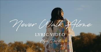 <p>Rest assured in His loving presence as you listen and watch this official lyric video of &ldquo;Never Walk Alone&rdquo; by Hope Darst.</p>

<p>Fittingly, the video focuses significantly on the artist&rsquo;s feet, a visual reminder that He is with us in every step we take. Hope walks barefoot along mown pathways, narrow and wide, carved within tall fields of golden grasses.&nbsp;</p>

<p>She sometimes dangles her hand, allowing her fingers to touch the various textures of the waist-high stalks. At other times, she holds a patchwork quilt around her shoulders. Her white fingernails and dress provide the perfect compliment to her dark hair and the flaxen field.&nbsp;</p>

<p>And every perfect image seems to provide a metaphor to accompany the words of her song&mdash;each listener is able to decide exactly what that is when examined next to their own experiences.&nbsp;&nbsp;</p>

<p>The video is beautiful, but the images work in tandem to Hope&rsquo;s message.&nbsp;</p>

<p>Here are a <a href="https://www.azlyrics.com/lyrics/hopedarst/neverwalkalone.html">few lines</a> from &ldquo;Never Walk Alone&rdquo;:&nbsp;&nbsp;&nbsp;&nbsp;&nbsp;&nbsp;&nbsp;</p>

<p>I'm a witness to Your faithfulness<br />
In every storm, in every step<br />
Looking back never once did You let me go</p>

<p>For believers, the message is universal, constant, and undeniable. Check out some of the comments. Many identify with the song, having experienced the company of Jesus in their trials and sorrows. One relays an experience of physical healing after a debilitating accident.&nbsp;&nbsp;</p>

<p>One person shares a salvation experience, having turned from the Muslim faith to Christianity after Jesus appeared to him. Many others simply thank Hope for her words that don&rsquo;t merely offer hope, but rather take-it-to-the-bank assurances.&nbsp;</p>

<p>&ldquo;Never Walk Alone&rdquo; is a reminder to believers, but perhaps more importantly, it is a declaration and the most helpful hack around for those that do not know Him!</p>

<p><a href="https://www.hopedarst.com/">Ms. Darst</a> is a 42-year-old Nashville-based wife and mom to two daughters. She is also a Christian singer, songwriter, and worship leader.&nbsp; Hope&rsquo;s 2020 debut album includes two singles that earned her <a href="https://en.wikipedia.org/wiki/Hope_Darst">three GMA Dove Award nominations</a>: &ldquo;Promise Keeper&rdquo; and &ldquo;<a href="https://www.jubileecast.com/articles/23137/20200209/hope-darst-shares-her-own-journey-that-led-her-to-debut-single-peace-be-still.htm">Peace Be Still.</a>&rdquo;&nbsp;&nbsp;</p>

<p><em>Keep your lives free from the love of money and be content with what you have, because God has said, &ldquo;Never will I leave you; never will I forsake you.&rdquo;&rsquo; <a href="https://www.godtube.com/bible/hebrews/13-5">Hebrews 13:5</a></em></p>
