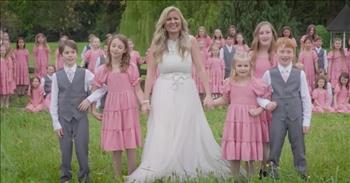 <p>A woman and dozens of children beautifully performed a medley of recognizable and beloved tunes.</p>

<p>There are several classic and iconic songs of worship and praise and many likely know those lyrics by heart. Anyone who has attended a church service knows &ldquo;Amazing Grace&rdquo; verbatim. It has been performed thousands of times by hundreds of artists. To this day, it remains a favorite of many. &ldquo;Victory in Jesus,&rdquo; &ldquo;How Great Thou Art&rdquo; and &ldquo;Great is Thy Faithfulness&rdquo; are just a few of the many other widely recognized church hymns.</p>

<p>Other favorite songs of worship and praise include &ldquo;Jesus Loves Me,&rdquo; &ldquo;Jesus Loves Even Me&rdquo; and &ldquo;And Can it Be, That I Should Gain?&rdquo; In a <a href="https://www.youtube.com/watch?v=BR-MF-pOTgw">video posted on YouTube</a>, Rosemary Siemens leads dozens of children in a unique mashup of these three songs about Christ&rsquo;s unbelievable and unfailing love and grace.</p>

<p>The 5-and-a-half-minute clip begins with Rosemary sitting at and playing the piano while she sings the opening words to &ldquo;Jesus Loves Me.&rdquo;&nbsp;</p>

<p>Seconds after the song begins, one young lady appears on screen and walks up to Rosemary, joining her at the piano. Then another child, a young man, walks into the frame and finds a place around the large instrument. A seemingly endless lineup of children finds their way into the room and soon Rosemary is surrounded by youngsters.&nbsp;</p>

<p>Around the 50-second mark, the children join Rosemary by singing the memorable and lovely chorus to &ldquo;Jesus Loves Me.&rdquo; Then, after completing the chorus, Rosemary and the children head outside, where they are met by dozens of other children standing in a field,&nbsp; also singing &ldquo;Jesus Loves Me.&rdquo;</p>

<p>Then, at about the halfway point of the clip, Rosemary and the children change things up. They go right into &ldquo;Jesus Loves Even Me&rdquo; without missing a beat.&nbsp;</p>

<p>Rosemary and the children end the clip by singing a few lines from the iconic &ldquo;And Can it Be, That I Should Gain?&rdquo; hymn.</p>

<p>In addition to displaying her beautiful voice and talent on the piano, Rosemary also shows what she can do on the violin. Rosemary, much like the children she performed with, has a ton of musical ability and talent.&nbsp;</p>

<p><em><a href="https://www.godtube.com/bible/romans/5-8">Romans 5:8</a> &ldquo;But God has made clear his love to us, in that, when we were still sinners, Christ gave his life for us.&rdquo;</em></p>
