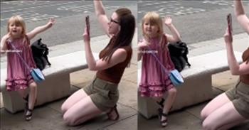 <p>A woman and her young daughter felt so moved during a street musician&rsquo;s performance that they fell to their knees and began praising the Lord in public.</p>

<p>Those lucky enough to become parents have been given a monumental task and responsibility. They have literally been entrusted with raising and teaching the next generation. Children, who are eager to learn, are always watching and listening to their parent&rsquo;s words and actions. How parents act and what they say will have a big impact on their child&rsquo;s development and life.</p>

<p>A <a href="https://www.youtube.com/shorts/jDZYjiuv5_Y">clip posted on YouTube</a> shows how a mother is using her influence to teach her young child how important it is to praise and thank the Lord. The short video shows a mom and her little girl on the side of the street as a musician can be heard playing in the distance, off camera.&nbsp;</p>

<p>While it&rsquo;s unclear who is performing, there is no question as to what song is being played. The mother and her child are listening to &ldquo;Way Maker.&rdquo;&nbsp;</p>

<p>As the song plays, the mother is down on her knees, with her right hand raised in the air, praising the Lord. In the mother&rsquo;s left hand is a cell phone, which she looks to be filming her little girl, sitting on a bench right in front of her. The little girl, emulating her mother, also has her hand raised, signaling praise for God.</p>

<p>Both praise the Lord as several other people on the other side of the street can be seen. Neither of them is letting the fact that they are in public stop them from praising the Lord.&nbsp;</p>

<p>This mother, by her actions, is demonstrating to her little girl how important it is to praise and thank the Lord, regardless of the location and what others may say or think.</p>

<p><em><a href="https://www.godtube.com/bible/proverbs/22-6">Proverbs 22:6</a> &ldquo;Train up a child in the way he should go, and even when he is old, he will not depart from it.&rdquo;</em></p>
