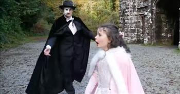 <p>This incredible daddy-daughter duet to &ldquo;Phantom of the Opera,&rdquo; from the classic, beloved musical of the same name, will leave you wowed in a variety of ways. Check it out!</p>

<p>For those who have a love for the &ldquo;Emerald Isle&rdquo; and its stunning beauty, those who have a fascination for the tragic, romantic story of &ldquo;The Phantom of the Opera,&rdquo; and everyone who enjoys watching a little girl sing her precious heart out&mdash;this is one to watch!&nbsp;&nbsp;</p>

<p>Adorable <a href="https://emma-sophia.com/bio">Miss Emma Sophia</a>, looking like a pink variation of Little Red Riding Hood, has got serious vocal range and power in that little body of hers! She portrays the play&rsquo;s heroine, Christine Daa&eacute;, and her dad, of course, is Erik (better known as The Phantom).</p>

<p>Emma lives in Kinsale, Co. Cork in Ireland, and <a href="https://en.wikipedia.org/wiki/Ballysaggartmore_Towers">Ballysaggartmore Lodge and Towers</a> in Lismore, Co. Waterford, Ireland, is the setting for the video. While not the hidden spaces within the innards of a theater, it is divinely mysterious and mystical. The forest and towers, built in the early 1800s, combined with the doom-promising music, certainly create a creepy vibe. However, the 7-year-old sprig of a girl is anything but creepy&mdash;even though she plays the part well!</p>

<p>Emma lands the first note confidently at 16 seconds. She is commanding, hitting the low notes and the high ones on cue. As she walks toward one of the towers, she is greeted on the walkway by the story&rsquo;s masked villain. Dad begins his part at 1:01. He&rsquo;s no musical slouch, either!</p>

<p>At about 1:50, Emma expertly invokes a gesture with the words &ldquo;draw back in fear.&rdquo; And she and Dad both add expression as they sing. The camera pans out to show the wooden landscape and then shoots the two from above as they circle each other on the tower-connecting bridge below. There&rsquo;s an awesome close-up of Emma at 2:50. We see her blue eyes, fair complexion, soft brown ringlets, and poochy child&rsquo;s mouth.</p>

<p>Christine (Emma) strides away from The Phantom (Dad), and, before long, she is singing those high notes. It&rsquo;s a good thing there aren&rsquo;t crystal wine glasses around!</p>

<p>Encore, <a href="https://www.facebook.com/EmmaSophiaShow/">Emma</a>! We&rsquo;ll be keeping our eyes on you!&nbsp;&nbsp;</p>

<p><em>&ldquo;Anger is cruel, and wrath is like a flood, but jealousy is even more dangerous.&rdquo; <a href="https://www.godtube.com/bible/proverbs/27-4">Proverbs 27:4</a></em></p>
