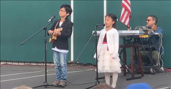 <p>Check out this adorable outdoor talent show performance. Young siblings captivate with a beautiful, &lsquo;A Thousand Years&rsquo; rendition.</p>

<p>At the start of the video, the two student hostesses introduce a brother and sister as the audience cheers. The precious little ones enter the stage. The boy is dressed in a suit jacket, and the girl is in a pretty dress. The boy makes sure that his ukulele is set to go, then he begins playing the ukulele. As the girl sings, it will melt your heart. Her voice is so cute. The duo is confident and absolutely adorable. They give this performance their all.&nbsp;</p>

<p>As this little girl sings about being brave, it is encouraging and brave of her to stand and sing in front of a large audience. Suddenly, she looks over at her big brother and the two of them sing the final chorus in unison. They build up the song beautifully and intentionally with great musicianship. The two work together to create music as a team. It is not a competition, but rather it is a unified partnership. At the end of their song, the large school audience cheers for this pair. You can hear a woman in the background saying, &ldquo;That was so good.&rdquo;&nbsp;</p>

<p>Little ones who come out and do something bold like this are inspiring. They remind us that we can also be brave, try new things, and use our talents. God has gifted each of us uniquely. He has empowered us by His Spirit to use our gifts to glorify Him and testify of His gospel of hope to the world. As we are proud to be watching these kids perform, may it remind us that our heavenly Father is very proud of us too, when we use the gifts He has entrusted to us. Even our smallest moments dedicated to Him are not wasted.</p>

<p><em>&ldquo;Whatever you do, work heartily, as for the Lord and not for men, knowing that from the Lord you will receive the inheritance as your reward. You are serving the Lord Christ.&rdquo; <strong><a href="https://www.godtube.com/bible/Colossians/3-23">Colossians 3:23-24</a></strong></em></p>
