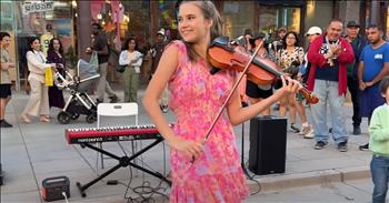 <p>Amidst the hustle and bustle of a lively street corner, Karolina Protsenko is a unique gift of musical grace and joy. Her vibrant pink flowered dress and the way she twirls and dances with her violin, which seems to sing with the beauty of her soul, are a sight to behold. Her performances, a blend of enchanting melodies and heartfelt expressions, are proof of her God-given incredible talent.</p>

<p>Karolina brings a timeless classic to life in her latest video, which has touched the hearts of <a href="https://www.youtube.com/watch?v=Uka3ZUNdkPg">788,871 </a>viewers. Her cover of Bob Dylan's &lsquo;Knockin' on Heaven&rsquo;s Door&rsquo; is not just a performance; it&rsquo;s talent and fun captured in the notes of her violin strings. The song, originally <a href="https://www.youtube.com/watch?v=Uka3ZUNdkPg">written </a>for the soundtrack of the 1973 film Pat Garrett and Billy the Kid, resonated with worldwide audiences. Karolina&rsquo;s rendition, accompanied by her six-year-old brother Leo, adds a fresh and heartfelt dimension to this beloved piece.</p>

<p>As Karolina plays, her violin seems to dance with her, and with each note, a delicate brushstroke on the canvas of the street. The pink of her dress spins in harmony with the music, creating a visual symphony that complements the auditory beauty of her performance. Her dance is not just an accompaniment to her music; it&rsquo;s a part of it, each movement perfectly timed to the melody and rhythm. The joy and passion she pours into every note are palpable, transforming a simple street corner into a stage of divine expression.</p>

<p>God&rsquo;s gift to Karolina is evident in her ability to connect with her audience. Her ability to stir deep emotions through her music is a powerful reminder of how talents, when used for good, can touch hearts and bring people closer to something greater. Her violin is more than just an instrument; it&rsquo;s a vessel through which God&rsquo;s grace and beauty flow, touching everyone who hears it.</p>

<p>The presence of Leo, her young brother, joining in on this musical journey adds a layer of familial warmth and joy to the performance. Their collaboration celebrates their shared talent and their bond, making the performance even more special. It&rsquo;s a beautiful example of how music can unite and uplift people in harmony and love.</p>

<p>As you watch Karolina&rsquo;s performance today, let it remind you of the incredible gifts we are given and how we can share them with the world. Her music is a gift to all of us, a beautiful dance of sound and motion that invites us to pause, listen, and appreciate the wonder of God&rsquo;s creation.</p>

<p>We hope you enjoyed this music video as much as we did. Karolina Protsenko&rsquo;s street performance is not just a display of talent; it&rsquo;s a celebration of the divine beauty that can be found in everyday moments and a testament to the power of sharing one&rsquo;s gifts with the world.</p>

<p><em><strong><a href="https://www.godtube.com/bible/psalms/33-3">Psalm 33:3</a></strong> &ldquo;Sing to him a new song; play skillfully, and shout for joy.&rdquo;</em></p>
