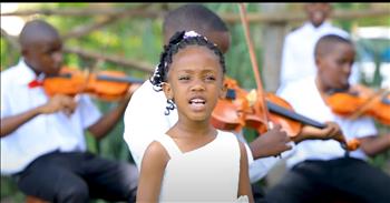 <p>Prepare to see one of the most precious groups of children performing a classic worship song. Check out a large ensemble&rsquo;s stunning rendition of &lsquo;Because He Lives.&rsquo;&nbsp;</p>

<p>At the start of this video, we see five violinists playing together in nice clothing. Mbarara Music School is located in Uganda. All of the singers are dressed in button-downs with bow ties and dresses. The soloist has a precious voice in the verse. When the chorus begins, all of the children join in with their instruments and voices. One little girl in particular has a lot of personality and is super fun. She is singing with passion.&nbsp;</p>

<p>We see some adults holding young children and participating as well. These kids are celebrating that life is valuable because Jesus lives and He loves us. We hear a stunning instrumental with the strings and keys. In the final verse, an adult sings as he holds a baby. The adult women join in harmony with him. They have lovely voices that blend really well together.&nbsp;</p>

<p>After, we hear the voices of the kids again for the chorus and it melts our hearts. The little ones will bring a smile to your face and cause you to join in singing that God is in control and Jesus lives, so our lives are worth living. At the very end, a sweet child sings the final line to the chorus, and it will bless you to hear and worship along with these children. I love hearing about a different nation worshipping the same Jesus. It motivates us that every tribe and tongue will one day worship Christ.</p>

<p><em>&ldquo;After this I looked, and behold, a great multitude that no one could number, from every nation, from all tribes and peoples and languages, standing before the throne and before the Lamb, clothed in white robes, with palm branches in their hands.&rdquo; <strong><a href="https://www.godtube.com/bible/Revelation/7-9">Revelation 7:9</a></strong></em></p>
