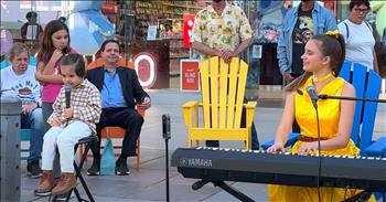 <p>In under two minutes, this adorable 3-year-old steals the hearts of many with his precious performance of &lsquo;Amazing Grace.&rsquo; <a href="https://karolinaprotsenko.com/catalog/biography">Karolina Protsenko</a>, born October 3, 2008 in Ukraine, has become a familiar face to many, particularly to those living in the Santa Monica, California area. Karolina has been busking there since 2017; the family moved to the United States in 2015.</p>

<p>Karolina&rsquo;s primary instrument is the violin, and she is brilliant! However, during a recent street performance, Karolina&rsquo;s 3-year-old brother asked to sing with her. His request was one of the most beloved hymns of all time. Karolina obliged and provided the piano accompaniment for his cover of &lsquo;Amazing Grace.&rsquo;&nbsp;</p>

<p>The little man, dressed in a flannel shirt, carpenter pants, and boots, hopped up onto the stool. Notice the yellow band in his hair; it matches Karolina&rsquo;s bright yellow satin dress and younger brother Leo&rsquo;s costume&mdash;Belle and Beast.</p>

<p>Karolina&rsquo;s parents are musicians, and her two younger brothers are musically inclined as well. Here, Nicholas is the star, but we think his singing may very well have touched those on the street and watching online with a message beyond his incredible cutest!</p>

<p>Little girls are fascinated by the performers, lingering nearby with a sense of awe. But it isn&rsquo;t just</p>

<p>the children who are transfixed. Many record Nicholas, and many others simply listen and enjoy his single chorus and verse. Precious little boy! Precious grace!</p>

<p>Our Heavenly Father can use anyone of any age to send a message for His kingdom. There are nearly 450 comments on the YouTube video, which has been viewed 720,000 times!</p>

<p>Among those many praises regarding Nicholas and Karolina&rsquo;s talent, character, and charm, here are two that speak to the spiritual impact of their public, musical declaration.&nbsp;</p>

<p>User @carlvaz wrote, &ldquo;Amazing! What a preacher! I am sure this little one has already converted a few hearts and minds!&rdquo;</p>

<p>&ldquo;So very sweet and heart touching. &lsquo;Amazing Grace&rsquo; is truly amazing when one comes to know it, just as a child we come to know Jesus Christ in our hearts. This is so beautiful and special,&rdquo; commented @freddykagin.&nbsp;</p>

<p>Well done, Nicholas!</p>

<p><em>&ldquo;Praise the Lord. How good it is to sing praises to our God, how pleasant and fitting to praise him!&rdquo; <strong><a href="https://www.godtube.com/bible/psalms/147-1">Psalms 147:1</a></strong>&nbsp;</em></p>
