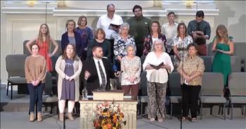 <p>Take a step back in time and enjoy this moving and uplifting rendering of &lsquo;Victory in Jesus&rsquo; by Mcferrin Missionary Baptist Church in Madison, Tennessee. We are so blessed by modern worship music; it is dynamic, powerful, and spirit-filled. However, it sure is nice to listen and sing to those old faithful hymns of years ago. Written in 1939 by Eugene Monroe Bartlett, &lsquo;<a href="https://follow-jesus-camp.blogspot.com/2016/01/the-story-behind-hymn-victory-in-jesus.html">Victory in Jesus</a>&rsquo; exclaims the promise of salvation and eternal life that we have in Jesus.</p>

<p>With the accompaniment of two guitarists and one pianist and the leadership of their choir director, a group of folks sing from the stage while congregants join in. The choir members range in age from senior citizens to teens. Some read lyrics from their hymnals; others don&rsquo;t. Though the worship pastor seems to have a bit of a cough, we can hear that he has a great voice.&nbsp;&nbsp;</p>

<p>Isn&rsquo;t it awesome that churches come in all sizes and shapes? If rousing and energetic worship music moves us closer to Christ, there are places that deliver. And, if old-school favorites touch our souls, there are buildings like Mcferrin Missionary Baptist Church still singing those comforting and timeless standards. Thankfully, we can enjoy both!&nbsp;</p>

<p>Sung beautifully by Mcferrin&rsquo;s choir and members, <a href="https://namethathymn.com/christian-hymns/victory-in-jesus-lyrics.html">here are a few lines</a> from &lsquo;Victory in Jesus:&rsquo;</p>

<p>&lsquo;I heard about a mansion He has built for me in glory.</p>

<p>And I heard about the streets of gold beyond the crystal sea;</p>

<p>About the angels singing and the old redemption story,</p>

<p>And some sweet day I'll sing up there the song of victory.&rsquo;</p>

<p><a href="https://en.wikipedia.org/wiki/Eugene_Monroe_Bartlett">Born on December 24, 1885</a> in Waynesville, Missouri, Eugene Bartlett <a href="https://namethathymn.com/christian-hymns/victory-in-jesus-lyrics.html">wrote in excess of 800</a> songs. &lsquo;Victory in Jesus&rsquo; is his most widely known. <a href="https://follow-jesus-camp.blogspot.com/2016/01/the-story-behind-hymn-victory-in-jesus.html">The music teacher</a> and songwriter opened schools and taught singing for over 20 years throughout Arkansas, Oklahoma, Texas, Alabama, and Tennessee. <a href="https://namethathymn.com/christian-hymns/victory-in-jesus-lyrics.html">One of the students</a> he mentored along the way was Albert E. Brumley, writer of &lsquo;I&rsquo;ll Fly Away.&rsquo; What a wonderful legacy these two musicians left!</p>

<p>Eugene Bartlett died on January 25, 1941, after suffering a stroke a couple of years earlier. No doubt, a mansion was waiting for Mr. Bartlett.</p>

<p><em>&ldquo;For everyone born of God overcomes the world. This is the victory that has overcome the world, even our faith.&rdquo; <strong><a href="https://www.godtube.com/bible/1-john/5-4">1 John 5:4</a></strong>&nbsp;</em></p>
