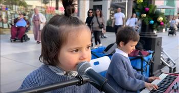 <p>Prepare to be blown away and encouraged by a little girl&rsquo;s voice and a little boy&rsquo;s piano skills. This street performance is absolutely adorable. Check out a 3-year-old&rsquo;s precious &lsquo;You Raise Me Up&rsquo; rendition.&nbsp;</p>

<p>It takes a lot of courage to perform live, but especially for a preschooler to be out in public sharing her voice. At the start of this video, we see two sweet little kids in blue sweaters playing and singing on a busy holiday filled sidewalk. You will melt as you hear this innocent voice of this tiny girl singing about being raised up. People on the streets gather to cheer them on and clap.&nbsp;</p>

<p>As she hits the chorus, you think about how truly impressive it is that a little one can remember these words and sing them publicly. One of the cutest things that she does is motion her shoulders as she sings about shoulders. You can see parents in the audience holding their own little ones and smiling as they watch.</p>

<p>There is a proud parent recording on video. So many people are smiling while observing. The girl just sits there comfortably on her chair with the boy next to her accompanying her while they perform with confidence. We even get a glimpse of famous violin performer, Karolina Protsenko, viewing in delight. At the end of the video, the young girl hits a higher note and the crowd applauds the performance.&nbsp;</p>

<p>Viewing such a young person singing lyrics about being raised up reminds us of Christ who actually raised Himself from the dead and raises us too when we believe in Him. We can be encouraged to know that Jesus raises us up from the darkest pits and hardest situations.&nbsp;</p>

<p><em>&ldquo;But God raised him from the dead, freeing him from the agony of death, because it was impossible for death to keep its hold on him.&rdquo; <strong><a href="https://www.godtube.com/bible/Acts/2-24">Acts 2:24</a></strong></em></p>
