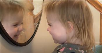 <p>A toddler&rsquo;s adorable reaction to her reflection will melt your heart. There are moments in life when pure wonder and innocence collide, creating memories in our hearts for years to come, especially the early years as parents. One of those moments is when this sweet little girl in Minnie Mouse pajamas sees her reflection in the mirror.&nbsp;</p>

<p>Unaware she is being filmed, she climbs up on a bench to reach the mirror. From there, she pauses to look at herself before uttering sounds at the little girl smiling back at her. At first, she stares at the reflection with a mix of confusion and delight&ndash;what is this tiny other little person in front of her? She leans in closer, uttering more sounds as if trying to figure out who the new friend is.&nbsp;</p>

<p>But then the magic happens. A big grin spreads across her face as she leans in and lets out a burst of giggles. It&rsquo;s as though a lightbulb went off, and she realized&ndash;this is ME! Her joy is infectious as she studies everything about herself, including her teeth. She bounces in front of the mirror and leans her hands on the wall as she smiles away and continues to babble. How can she not be entertained by the cute face in front of her?&nbsp;</p>

<p>The wonder in her eyes&ndash;it&rsquo;s a reminder of the simple joys in life and how each of us is masterfully woven together by God Himself. I loved watching the wonder in her eyes! What about you? Watching her discover herself in such an innocent and playful way will leave anyone smiling. Maybe we older folks need to take one from this little girl&rsquo;s playbook and smile in wonder at the wrinkles around our eyes and the gray coming into our hair.&nbsp;</p>

<p>If you need a dose of happiness today, take a moment to watch this heartwarming and funny video of our toddler&rsquo;s first mirror encounter. It&rsquo;s guaranteed to brighten your day.&nbsp;</p>

<p><em><strong><a href="https://www.godtube.com/bible/matthew/18-3">Matthew 18:3</a></strong> "I tell you the truth, unless you change and become like little children, you will never enter the kingdom of heaven."</em></p>
