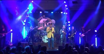 <p>There&rsquo;s something in the way music wraps itself around the soul, isn't there? It has this sacred ability to breathe life, fun, and laughter into the air, and when a performance strikes just the right chord, it feels like a brush with heaven. At least that&rsquo;s how this stunning performance of Elvis Presley&rsquo;s &lsquo;Suspicious Minds&rsquo; felt when Darren Mullen of Sing It Live brought it to life.&nbsp;</p>

<p>Dressed in a mustard yellow suit coat, jeans, and a black t-shirt. Darren was full of smiles as he gave his audience an incredible experience. He built his career as the <a href="https://www.youtube.com/watch?v=17HDQQ1xbKg">founder</a> of Sing It Live. He doesn&rsquo;t just produce music; he creates moments like an artist painting a canvas.&nbsp;</p>

<p>He paints the world with his voice and pours every ounce of his passion into creating a magical live musical and vocal performance that creates memories that linger. And linger, the performance does! There was so much fun and energy to this timeless yet fresh performance that echoed the legacy of Elvis while making it seem so stunningly new. &nbsp;</p>

<p>&lsquo;We can't go on together<br />
With suspicious minds (with suspicious minds)<br />
And we can't build our dreams<br />
On suspicious minds&rsquo;</p>

<p>Fun facts about the song include how it was released in <a href="https://en.wikipedia.org/wiki/Suspicious_Minds">1968</a> and first recorded by songwriter <a href="https://en.wikipedia.org/wiki/Suspicious_Minds">Mark James</a>. After the song failed to be noticed by the public, Elvis picked up the song and put a fresh spin on it. It reached the number one spot on the <a href="https://en.wikipedia.org/wiki/Suspicious_Minds">Billboard Hot 100</a> and in 1999, the song was included in the Hall of Fame.&nbsp;</p>

<p>Darren&rsquo;s vision for Sing It Live was more than just attributing the song to Elvis but bringing the song to life, creating a connection to the audience with a bit of nostalgia. As the last note of &lsquo;Suspicious Minds&rsquo; faded, the audience applauded, loving every moment. Music like this does more than entertain; it reminds us to feel deeply, love fully, and live with the kind of passion that leaves a legacy.&nbsp;</p>

<p><em><strong><a href="https://www.godtube.com/bible/psalms/33-3">Psalm 33:3</a></strong> "Sing to him a new song; play skillfully, and shout for joy."</em></p>
