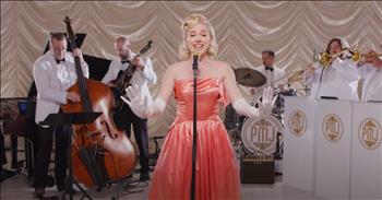 <p>A Faith Hill classic &lsquo;This Kiss&rsquo; gets a unique one-of-a-kind rendition that will leave you feeling delighted. That&rsquo;s exactly what <a href="https://www.youtube.com/channel/UCORIeT1hk6tYBuntEXsguLg">Postmodern Jukebox</a> has done with Faith Hill&rsquo;s beloved song. In their latest release, they&rsquo;ve reimagined the song with a delightful vintage flair, giving it a &ldquo;<a href="https://www.youtube.com/watch?v=SSxgU2JBE94&amp;ab_channel=PostmodernJukebox">Doris Day</a>&rdquo; style cover that&rsquo;s simply irresistible. Featuring the captivating Tatum Langley, this rendition is a charming nod to the romantic sounds of the past, blending nostalgia with fresh songs of today.</p>

<p>Picture Tatum Langley gracing the stage in a gown of crushed peach velvet, her hair elegantly styled in a vintage updo. She stands radiant at the center, surrounded by a band of gentlemen in crisp white tuxedos, each note they play echoing the romance of a bygone era. It&rsquo;s a scene that invites us to step back in time!</p>

<p>This rendition sounds like it should have been the original version of the song.&nbsp;</p>

<p>With over 112,000 <a href="https://www.youtube.com/watch?v=SSxgU2JBE94&amp;ab_channel=PostmodernJukebox">views</a> and hundreds of comments from fans chiming in about the song, it&rsquo;s no wonder it&rsquo;s become a fan favorite. Tatum's voice radiates warmth, effortlessly channeling that classic Hollywood vibe.&nbsp;</p>

<p>One fan <a href="https://www.youtube.com/watch?v=SSxgU2JBE94&amp;ab_channel=PostmodernJukebox">wrote</a>, &ldquo;My babe (20 months) just started laughing and dancing while listening to this song. Thanks for creating this happy moment!&rdquo;</p>

<p>&nbsp;Another talked about his personal experience with Tatum, he <a href="https://www.youtube.com/watch?v=SSxgU2JBE94&amp;ab_channel=PostmodernJukebox">wrote</a>, &ldquo;I had the great pleasure to play on a recording session with Tatum Langley for an album by Shout Section Big Band and I am so proud to see her continued success.&nbsp; She really is something special and an absolute delight to work with.&rdquo;&nbsp;</p>

<p>Another fan gushed about the band and Tatum, he <a href="https://www.youtube.com/watch?v=SSxgU2JBE94&amp;ab_channel=PostmodernJukebox">wrote</a>, &ldquo;While there's a lot to be said about her clear, unaffected, beautiful voice, let's hear it for that horn line!&nbsp; Masterfully arranged and played. Well done, PMJ!&rdquo;</p>

<p>If you&rsquo;re looking for a fresh perspective on a classic, Postmodern Jukebox&rsquo;s take on &lsquo;This Kiss&rsquo; is a must-listen.&nbsp;</p>

<p>It&rsquo;s a beautiful reminder to slow down and savor the moments that make life special&mdash;like a sweet kiss shared between two hearts. So, whether you&rsquo;re celebrating love or just want to revel in a joyful tune, let this enchanting rendition sweep you off your feet once again.</p>

<p><em><strong><a href="https://www.godtube.com/bible/1-john/4-19">1 John 4:19</a></strong>&nbsp; "We love because he first loved us."</em></p>
