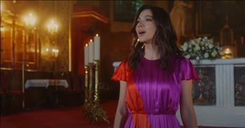 <p>The hush of the sanctuary held its breath during this stunning rendition of &lsquo;How Great Thou Art.&rsquo;</p>

<p>Stained glass caught the afternoon light, spilling rubies and sapphires across the marble floor as if heaven itself leaned close to listen. And there she stood&mdash;Laura Bretan, dressed in a flowing gown of crimson and royal purple, like the sky&rsquo;s final exhale before twilight.</p>

<p>Her voice rose, pure and unshaken, like the first tremor of dawn breaking over the hills. Her voice was a sacred invitation to step beyond the weight of the world and into the throne room of the Almighty.</p>

<p>Laura, this young woman who once stood on grand stages under the glare of <a href="https://laurabretan.com/">Hollywood&rsquo;s</a> lights, now stood at the altar of something far greater. The depth of her voice carried something richer than mere talent&mdash;it bore the weight of eternity. Every note, every syllable carved out space in the soul, making room for awe.</p>

<p>In a world spun dizzily with hurry, where screens flicker, and voices clamor for attention, her voice slowed time. It was the kind of sound that made you forget the pressing demands, the endless to-do lists, the headlines that steal breath. Instead, it made you remember&mdash;make you see&mdash;the stars flung wide, the thunder rolling in the distance, the hands that formed both galaxies, and the fragile pulse in your wrist.</p>

<p>Laura didn&rsquo;t just sing&mdash;she worshiped. And in that sacred offering, something shifted in the room. Because when a soul sings truth when it proclaims the greatness of God with nothing held back, it has a way of unraveling the knots in another&rsquo;s spirit.</p>

<p>How does one sing of the cross without trembling? Of love so vast, so incomprehensible, that it bore the weight of sin and shattered the curse of death? She sang it like she knew&mdash;like she had stood beneath that bloodstained wood, like she had seen the mercy poured out, like she had felt the nails in her own hands.</p>

<p>How could a song be both a thunderstorm and a whisper? How could it hold both the weight of the world and the lightness of grace? The final verse came, and the room could hardly contain it.</p>

<p>Her voice soared&mdash;higher, fuller, breaking through ceilings, through sky, through whatever veil separates earth from heaven. And then&mdash;silence.</p>

<p>Laura Bretan had done more than sing. She had ushered in the presence of God. And for those sacred minutes, the weight of glory had pressed close, and weary souls had remembered:</p>

<p>How great Thou art.</p>

<p>How great Thou truly art.</p>

<p><em><strong><a href="https://www.godtube.com/bible/1-chronicles/16-23">1 Chronicles 16:23</a></strong> "Sing to the Lord, all the earth; proclaim His salvation day after day."</em></p>
