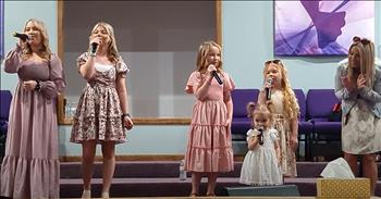 <p>The Detty sisters shine in &lsquo;I&rsquo;ll Fly Away,&rsquo; a live performance that featured the most precious of the group, their little sister Mercy. At church, the sanctuary lights danced softly on polished pews and beaming faces. It was Sunday morning in small-town Ohio, and heaven came close in that country church&mdash;the kind where babies squeal, the smell of coffee lingers in the foyer, and saints still shout &ldquo;Amen.&rdquo;</p>

<p>And there they were&mdash;The Detty Sisters&mdash;lined up like little stair steps on the church stage, dressed in a blush pink that looked like it had been kissed by a spring sunrise. Peyton, Cadie, Lily, and Sophia, each one glowing with the kind of joy you can&rsquo;t manufacture. Harmony just ran in their veins&mdash;like how daisies turn toward the sun without trying.</p>

<p>But today wasn&rsquo;t just any song. And it wasn&rsquo;t just any performance. Today, Mercy was singing.</p>

<p>The littlest of them all&mdash;just two years old with pig tails as precious as dandelions in bloom and a heart as brave as a lion cub. Mama, hands gentle and sure, lifted her up onto the stage. Her little white dress, soft with lace and truth, fluttered around her knees like angel wings as she stepped forward. She didn&rsquo;t need coaxing. She didn&rsquo;t need a cue. She just knew.</p>

<p>Her tiny fingers wrapped around the microphone like it was made just for her. She brought it close to her mouth, standing there like she had been singing since the day she took her first breath.</p>

<p>The first notes of &lsquo;I&rsquo;ll Fly Away&rsquo; floated into the room like hope on the wind, and the crowd couldn&rsquo;t help but clap and sway and sing along. But their eyes? They were on Mercy.</p>

<p>Eyes wide and locked onto the audience, she sang with all the sweetness two years could hold. And heaven? It bent low to listen. Her sisters smiled at her from both sides, voices lilting, harmonies hugging her melody like big sisters do&mdash;gracefully, protectively, joyfully.</p>

<p>There is nothing more holy than children praising the Lord&mdash;nothing more healing, more humbling, more heart-piercing. And on that morning, the church was reminded that worship doesn&rsquo;t need polish&mdash;it just needs purity.</p>

<p>The kind Mercy brought with her two-year-old voice ringing true, brave, and unshaken.</p>

<p>Because the Spirit doesn&rsquo;t wait until we&rsquo;re grown to move.<br />
Sometimes, the littlest ones show us how to fly.&nbsp;<br />
If this isn&rsquo;t the sweetest thing you will see today, I don&rsquo;t know what is. How precious!&nbsp;</p>

<p><em><strong><a href="https://www.godtube.com/bible/matthew/21-16">Matthew 21:16</a></strong> &ldquo;From the lips of children and infants you, Lord, have called forth your praise.&rdquo;</em></p>
