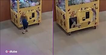Child Climbs Into Claw Machine and Gets Himself Stuck