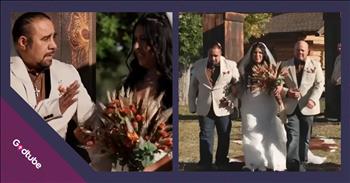 <p>One dad invited the stepdad to join him in walking his daughter down the aisle. This sweet and completely unexpected move will have you brushing away tears from your eyes. Watch the short but heartwarming clip to see the stepfather&rsquo;s response and everyone else&rsquo;s reaction.</p>

<p>Weddings are often incredibly emotional events, causing many to carry tissues just in case they spring a leak from their eyes. You may even get a little teary-eyed thinking about the last wedding you attended. It&rsquo;s entirely understandable why people would become emotional during a wedding ceremony. It&rsquo;s a big, life-changing event for the happy couple standing at the altar as they pledge their unending love to one another.</p>

<p>Nearly everything that&rsquo;s involved in a wedding ceremony carries much significance and meaning with it. That&rsquo;s likely part of the reason why planning a wedding typically requires several months. You want everything to be just right, with nothing out of place, which is entirely understandable.</p>

<p>Another great thing about weddings, as captured in a <a href="https://www.youtube.com/shorts/RbwGvHJdVeA">video posted on YouTube</a>, is that they can bring people together. A bride was about to make her grand entrance, walk down the aisle and meet her future husband waiting at the altar. Everything was set to go, but the father of the bride had something he had to do first. He made his way up the aisle by himself, approached the bride&rsquo;s stepfather, and asked him an important, and heartwarming question. He asks him to assist in walking his daughter down the aisle.</p>

<p>What a beautiful and classy move from the biological father. He did not have to do that, but he wanted the wedding to be about his daughter and her groom, not himself. That&rsquo;s likely to be a memory the bride will remember for years.</p>

<p><em><strong><a href="https://www.godtube.com/bible/genesis/2-24">Genesis 2:24</a></strong> &ldquo;For this cause will a man go away from his father and his mother and be joined to his wife; and they will be one flesh.&rdquo;</em></p>
