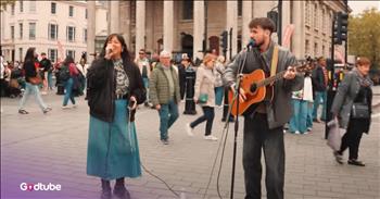 <p>The streets of London are never still&mdash;double-decker buses hum, footsteps hurry, conversations overlap in a dozen accents. It&rsquo;s the sort of place where life rushes by, where we&rsquo;re always trying to get to the next thing. But then&mdash;right there on the cobblestones&mdash;everything pauses when Whitney Houston&rsquo;s hit &lsquo;I Wanna Dance with Somebody&rsquo; gets a beautiful makeover. You can&rsquo;t help but stop, watch, and listen.&nbsp;</p>

<p>Two buskers stand shoulder to shoulder, their music floating through the crisp air. One is <a href="https://www.youtube.com/channel/UCJu2HW6m5LjV1i3-GneemCg">Atticus Blue</a>, a voice already known by many for its soulful depth. The other&mdash;a woman whose name we don&rsquo;t even know. And maybe that&rsquo;s the beauty of it&mdash;anonymity wrapped in a sound that feels like home.</p>

<p>Together, they took Whitney&rsquo;s iconic song, &lsquo;I Wanna Dance with Somebody,&rsquo; and stripped it down to something sweet, elegant, and beautiful. If we go back to when Whitney&rsquo;s song first came out, we remember the heat, the upbeat music, and the way it made our toes tap across the floor. But this time, it was slow and soft, and it was a chance to grab your partner&rsquo;s hand and spin once or twice on those old streets while strangers smiled because, for one musical moment, the whole world felt lighter.</p>

<p>There&rsquo;s something holy in it, isn&rsquo;t there? The way a song can hush the noise, slow the steps, and remind us that joy is meant to be shared. That maybe God tucked music into our bones because He knew we&rsquo;d need reminders of goodness in the middle of the ordinary.</p>

<p>And so, Atticus and this mystery woman became an unexpected duet&mdash;serenading shoppers, walkers, tourists, and dreamers alike. What a gift, really. To witness two strangers weaving joy into a gray London day. It&rsquo;s the kind of thing that makes you believe the world is still brimming with wonder if only we&rsquo;ll stop long enough to notice.</p>

<p>Don&rsquo;t you think?</p>

<p><em>&ldquo;Every good and perfect gift is from above, coming down from the Father of the heavenly lights, who does not change like shifting shadows.&rdquo; &nbsp;<strong><a href="https://www.godtube.com/bible/james/1-17">James 1:17</a></strong></em></p>
