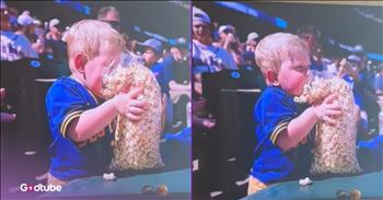 <p>This little baseball fan loves popcorn, and it&rsquo;s totally adorable. It&rsquo;s pretty evident that this young man&rsquo;s favorite treat is popcorn. Watch the short but hysterical clip to see how this little guy&rsquo;s love of the delicious treat cannot be questioned.</p>

<p>Baseball is America&rsquo;s pastime, right? Personally, I find watching a game of baseball to be one of the most boring things on Earth. Watching paint dry after it&rsquo;s been slathered upon a surface offers many more thrills and excitement than a nine-inning baseball game. Golf, as slow and boring as it is, might even provide spectators with a better viewing experience than a baseball game.</p>

<p>Nevertheless, despite the incredibly slow nature of the game, people still regularly attend baseball games. At those games, people will pick themselves up various treats (perhaps eating is a way for them to stay awake at a baseball game?). &nbsp;In addition to hot dogs, nachos and pizza, popcorn is another fan favorite when it comes to the concession stand. <a href="https://x.com/brittanyanne08_/status/1959728266509730204">In a clip posted on social media</a>, a young man was spotted at a baseball game enjoying a bag of popcorn. He literally throws himself headfirst into it.</p>

<p>In the video, the little guy is spotted holding a massive, overflowing bag of popcorn at a Seattle Mariners and Athletics game. The container of popcorn is about as big as he is. However, he does not let the size or the amount of popcorn intimidate him. He attacks the bag fearlessly and confidently, making for quite the spectacle.</p>

<p>As the video shows, the child has his entire face buried in the bag of popcorn as he scarfs down those popped kernels. Given his diminutive size and how much popcorn he has, going in face-first was probably the best way for him to go at it. Either way, it was still incredibly hilarious and cute!</p>

<p><em><strong><a href="https://www.godtube.com/bible/proverbs/22-6">Proverbs 22:6</a></strong> &ldquo;If a child is trained up in the right way, even when he is old, he will not be turned away from it.&rdquo;</em></p>
